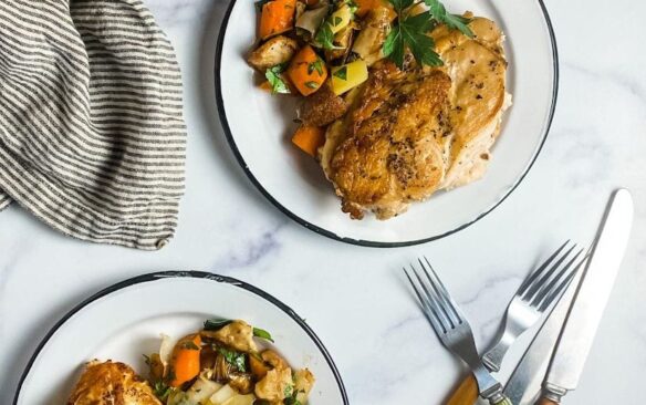 Chicken an vegetables served on plates.