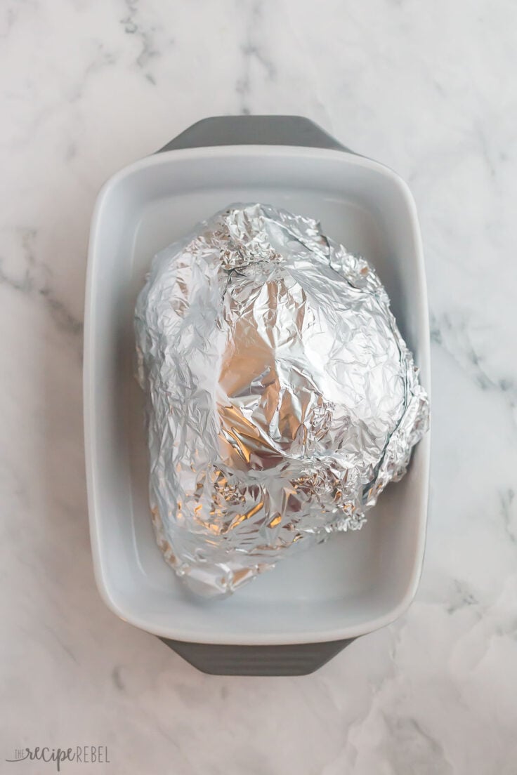 spiral ham wrapped in foil and ready to bake