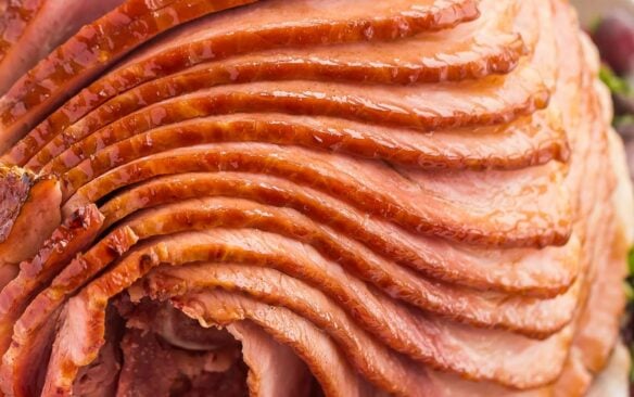 close up image of spiral ham on white platter