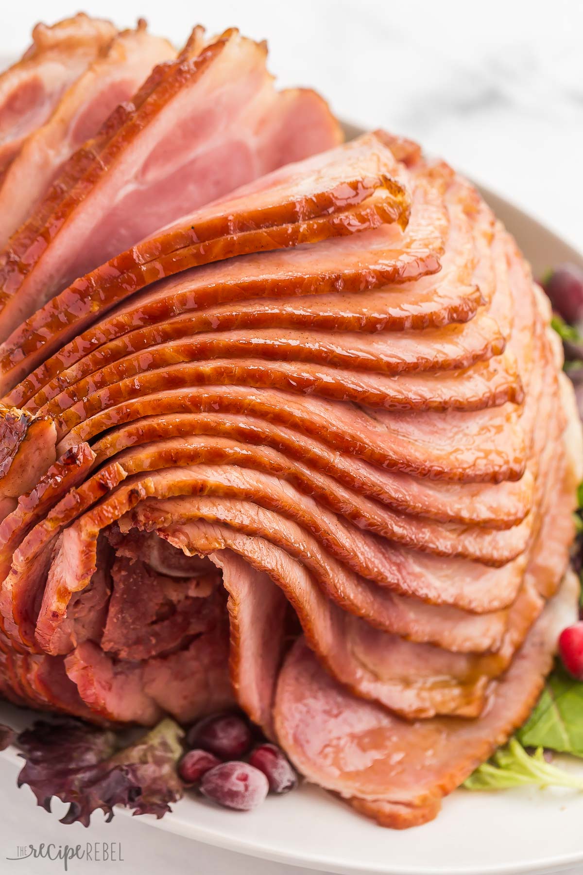 close up image of spiral ham on white platter