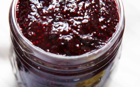 A mason jar filled with homemade blueberry chia jam.