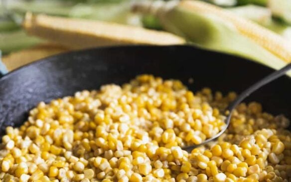 A skillet full of fried corn.