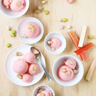 Top view of assorted bowls with scoops of pink rhubarb gelato.