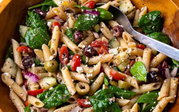 Mediterranean pasta salad in a large wooden bowl.