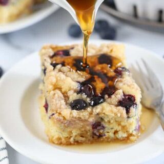 A serving of pancake casserole on a plate, drizzled with maple syrup.