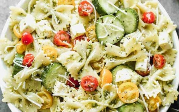 Top view of pesto salad in a large white bowl.