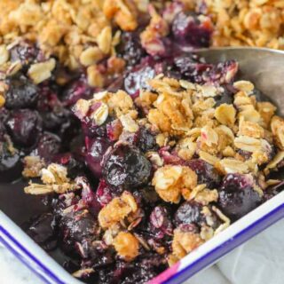 Blueberry crisp in a square baking dish.