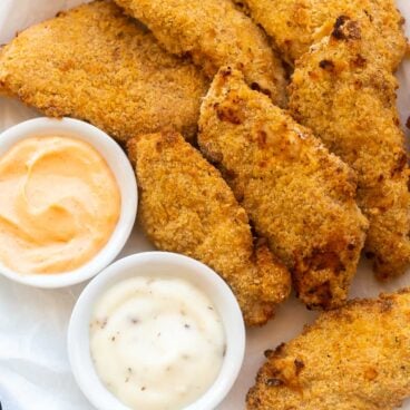 plate of air fryer chicken tenders with two dipping sauces