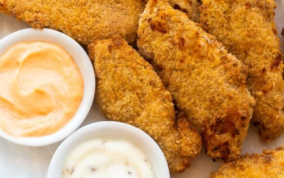 plate of air fryer chicken tenders with two dipping sauces