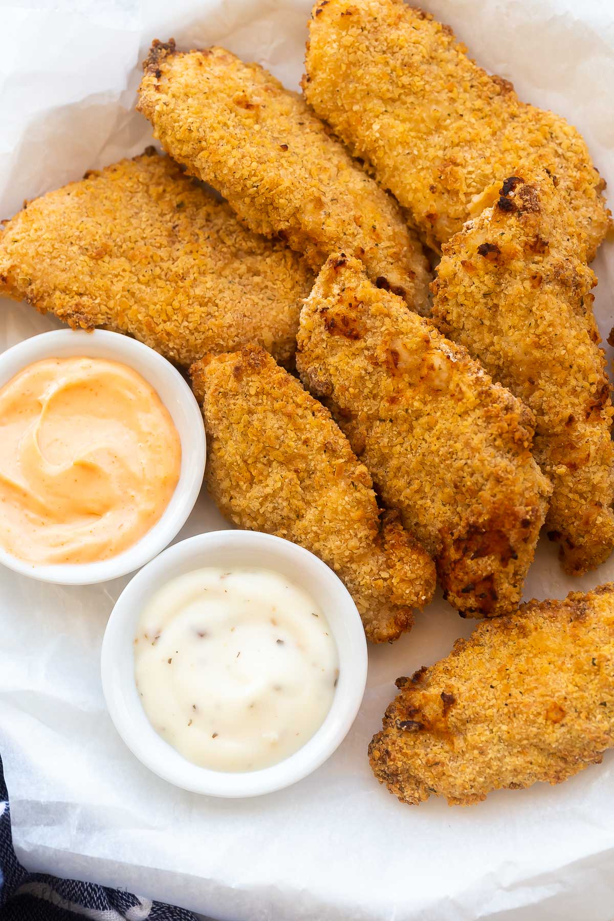 plate of air fryer chicken tenders with two dipping sauces