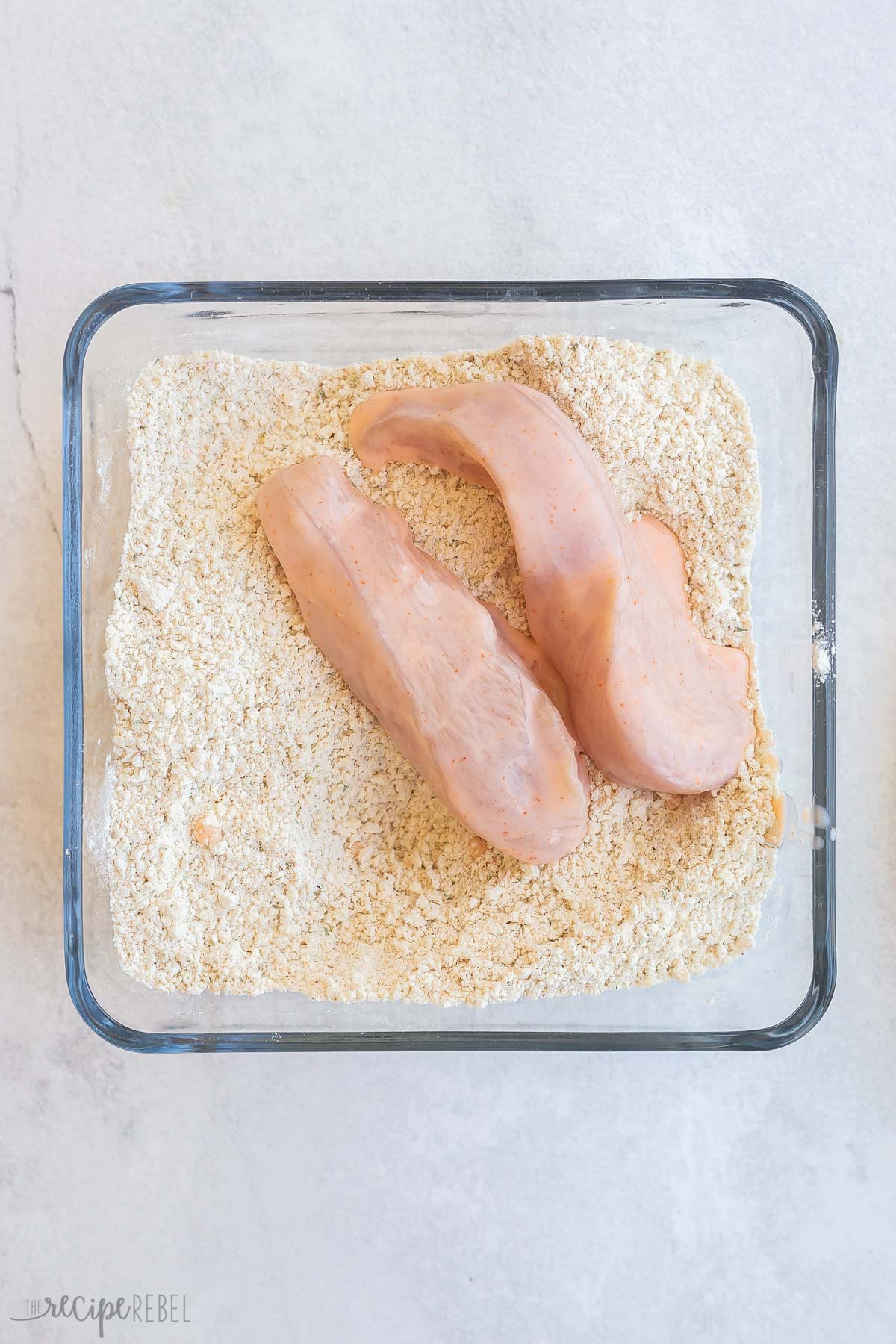 soaked chicken tenders added to breading mixture to coat