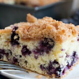 A slice of blueberry buckle on a plate.