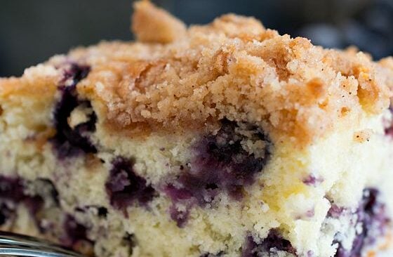 A slice of blueberry buckle on a plate.