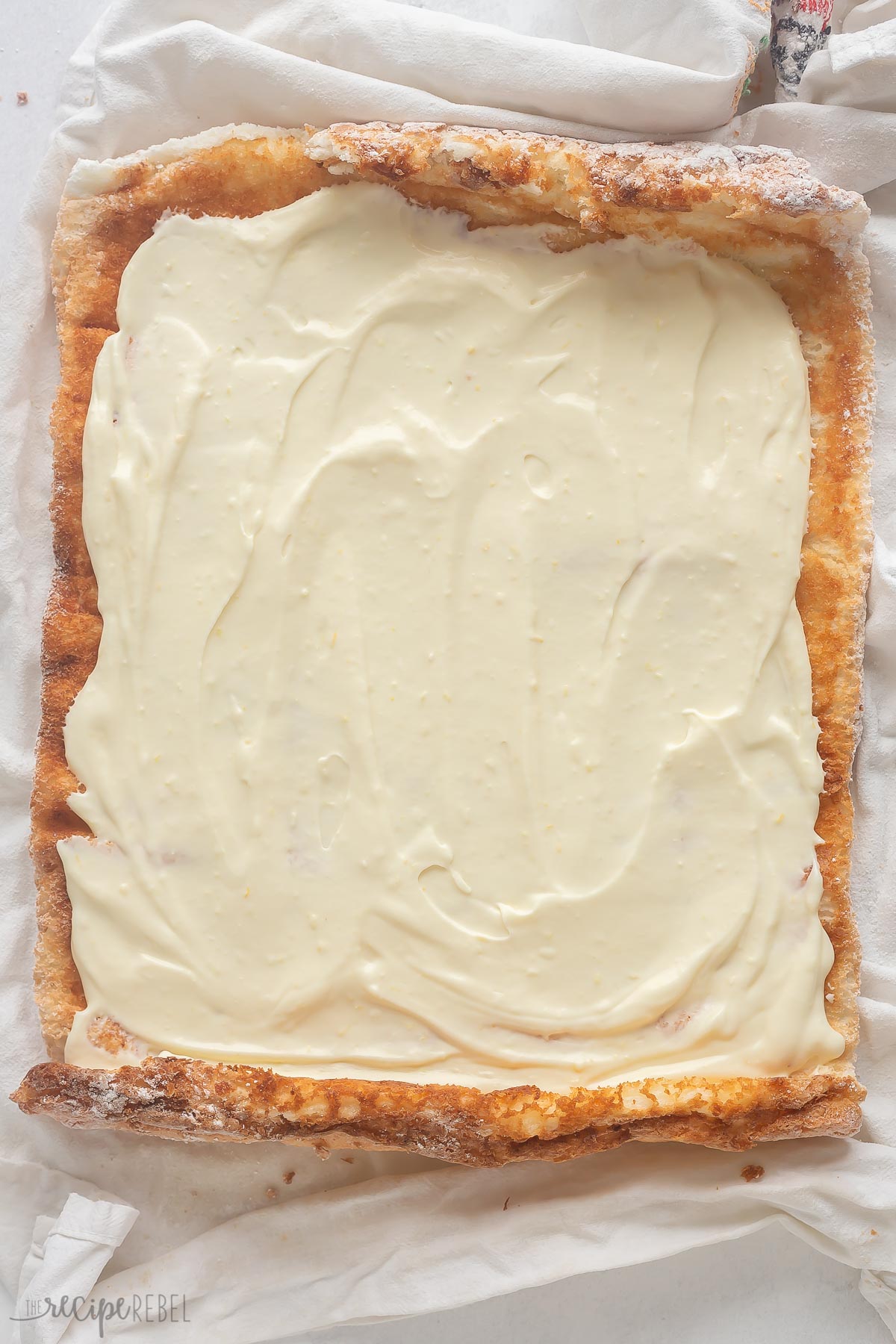 spreading angel food cake with lemon cream cheese filling