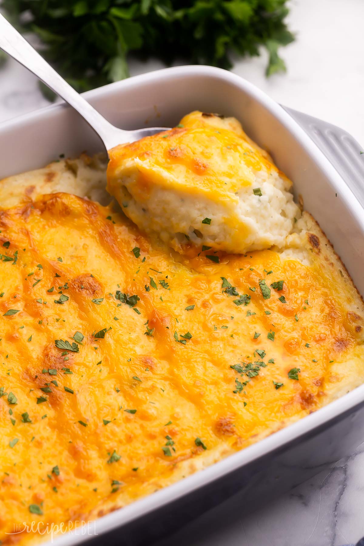 make ahead mashed potatoes in baking dish with metal spoon.