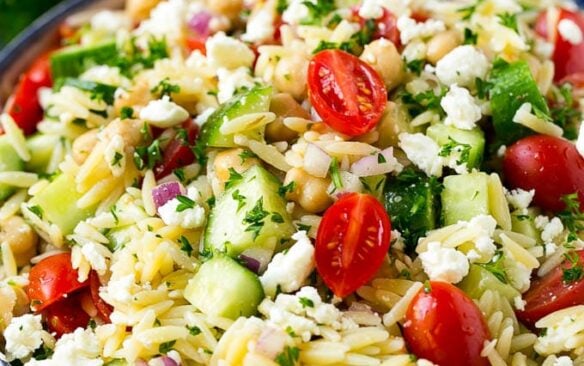 Close up of a bowl of orzo pasta salad.