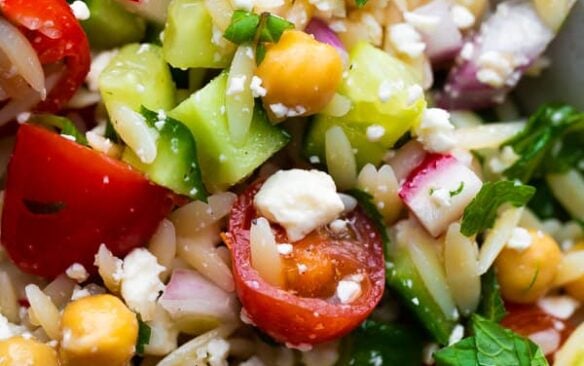 Close up of a bowl of orzo pasta salad.