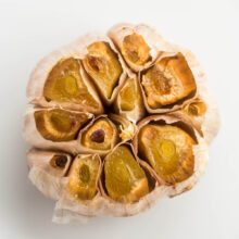 close up overhead image of roasted garlic head