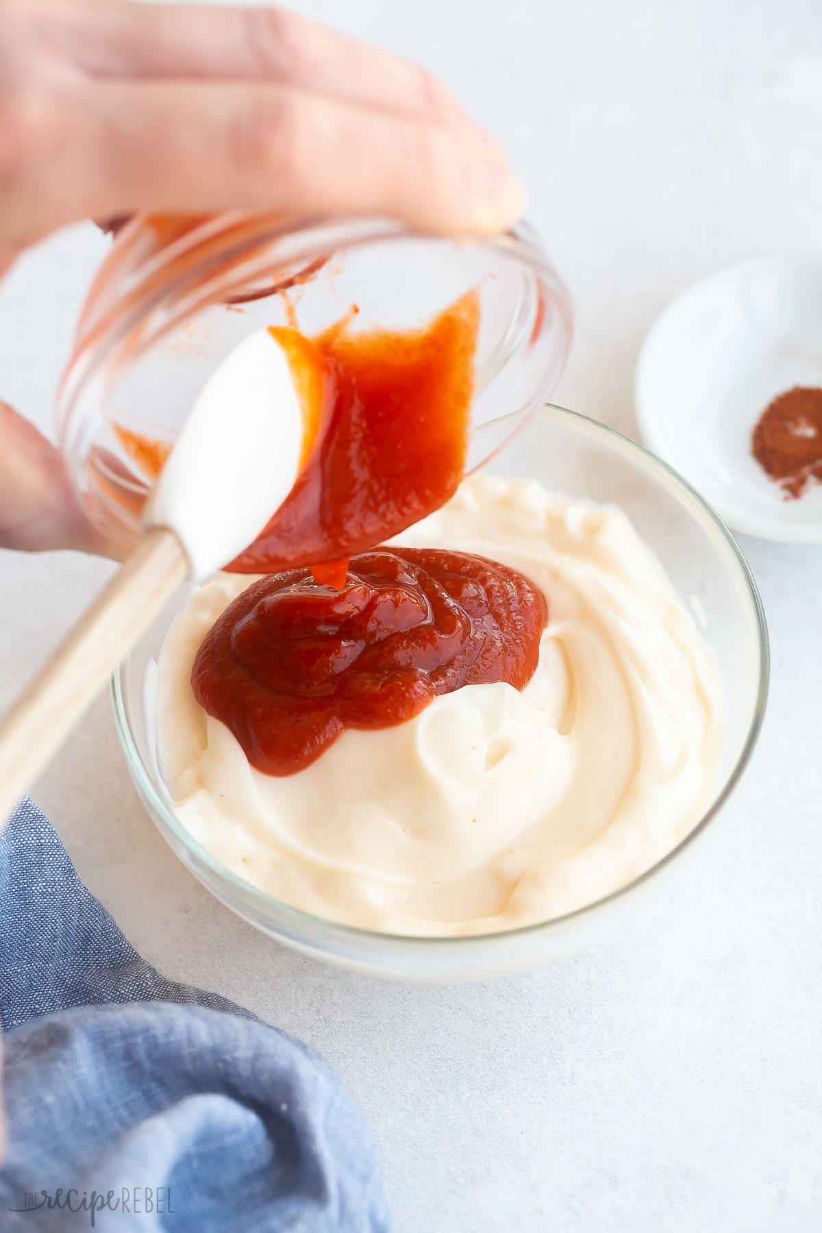 sriracha sauce being added to mayonnaise