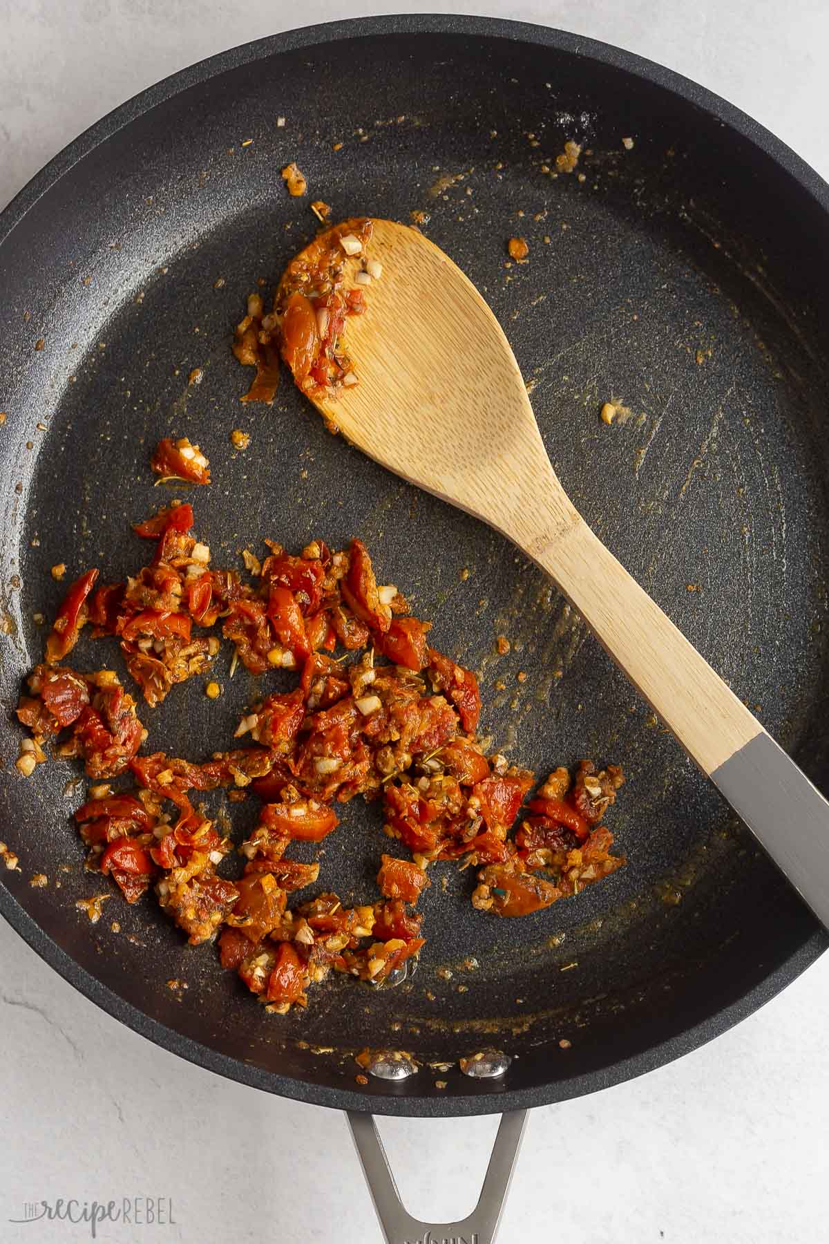 sun dried tomatoes and spices sauteeing in skillet