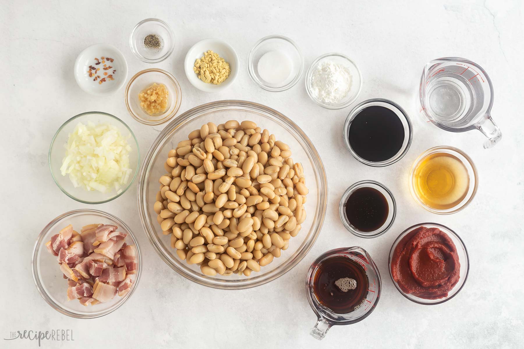 ingredients needed for maple bacon baked beans on white background.