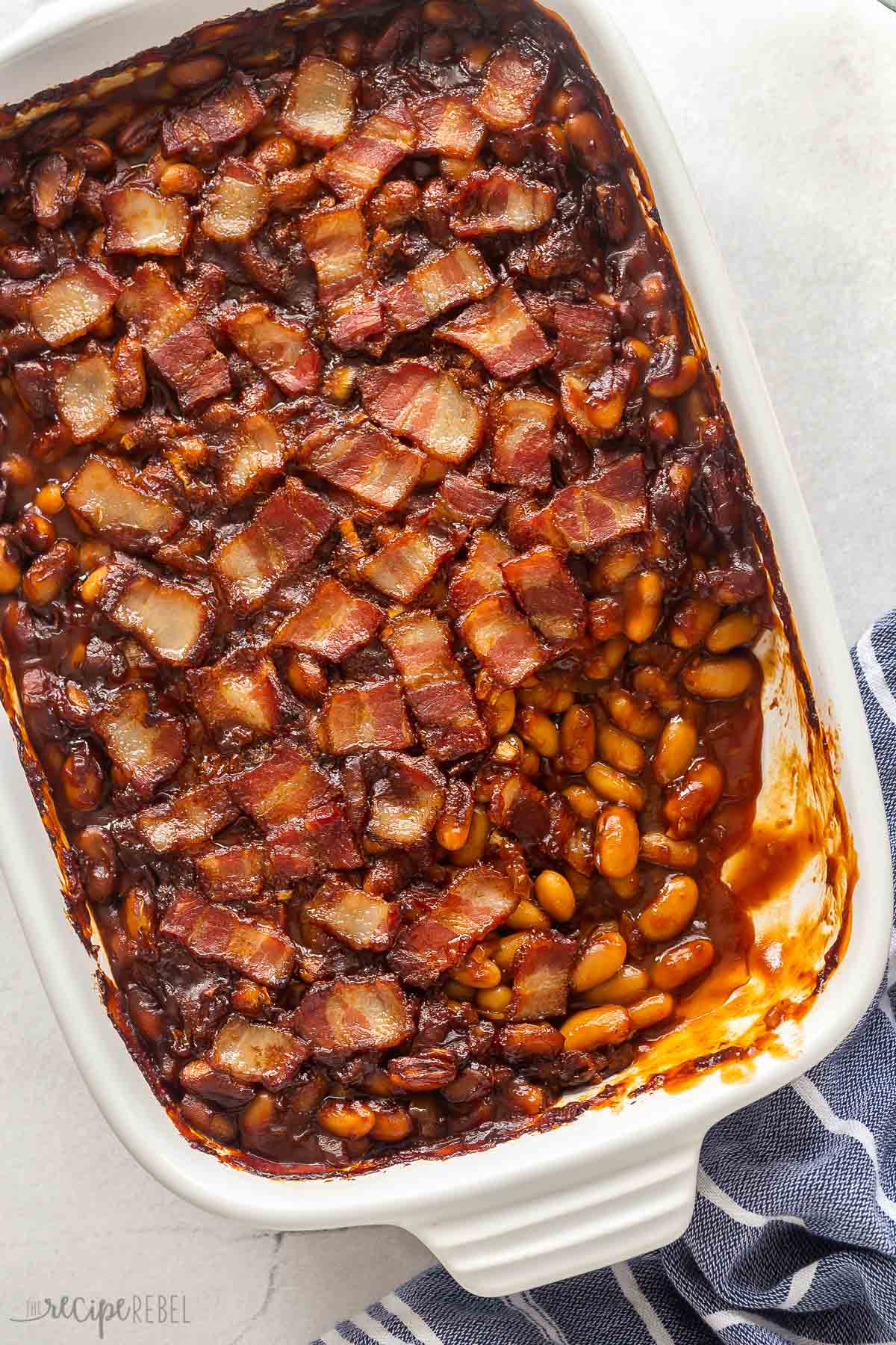 overhead image of baked beans in white baking dish.