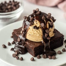 close up image of finished brownie sundae on white plate.