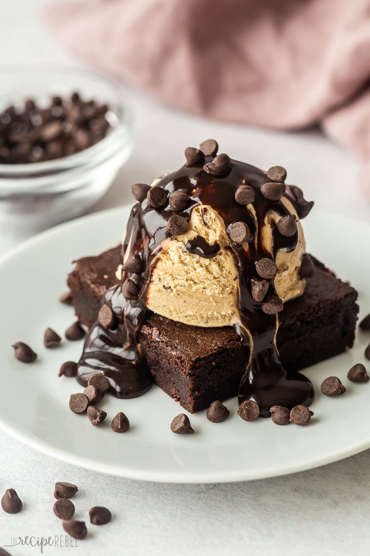 close up image of finished brownie sundae on white plate.