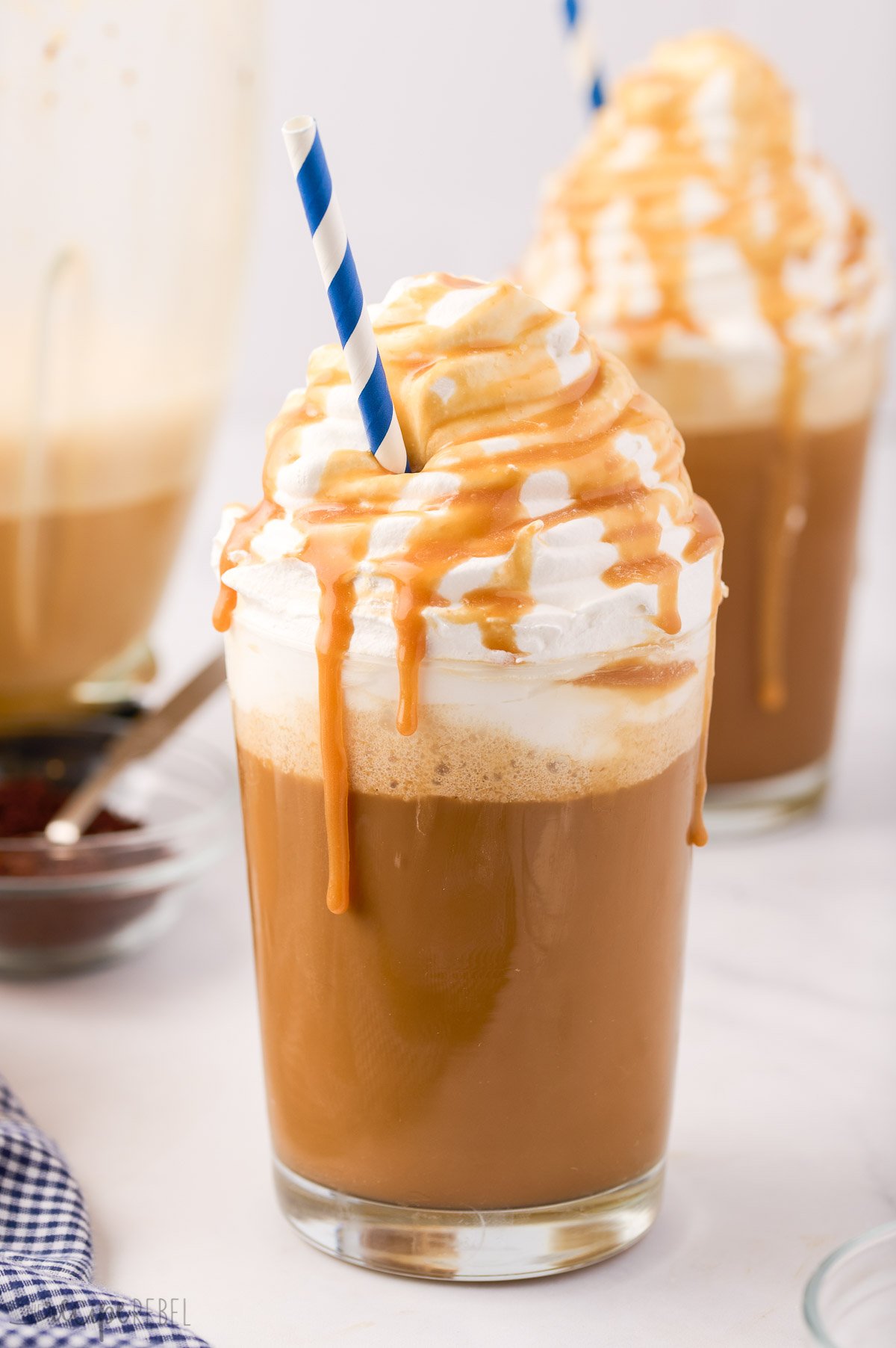 Iced coffee cocktail or frappe with ice cubes and cream in