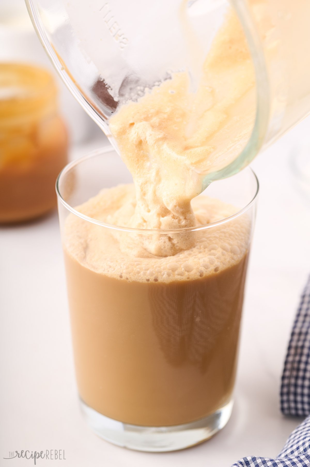 blended frappuccino being poured into glass.