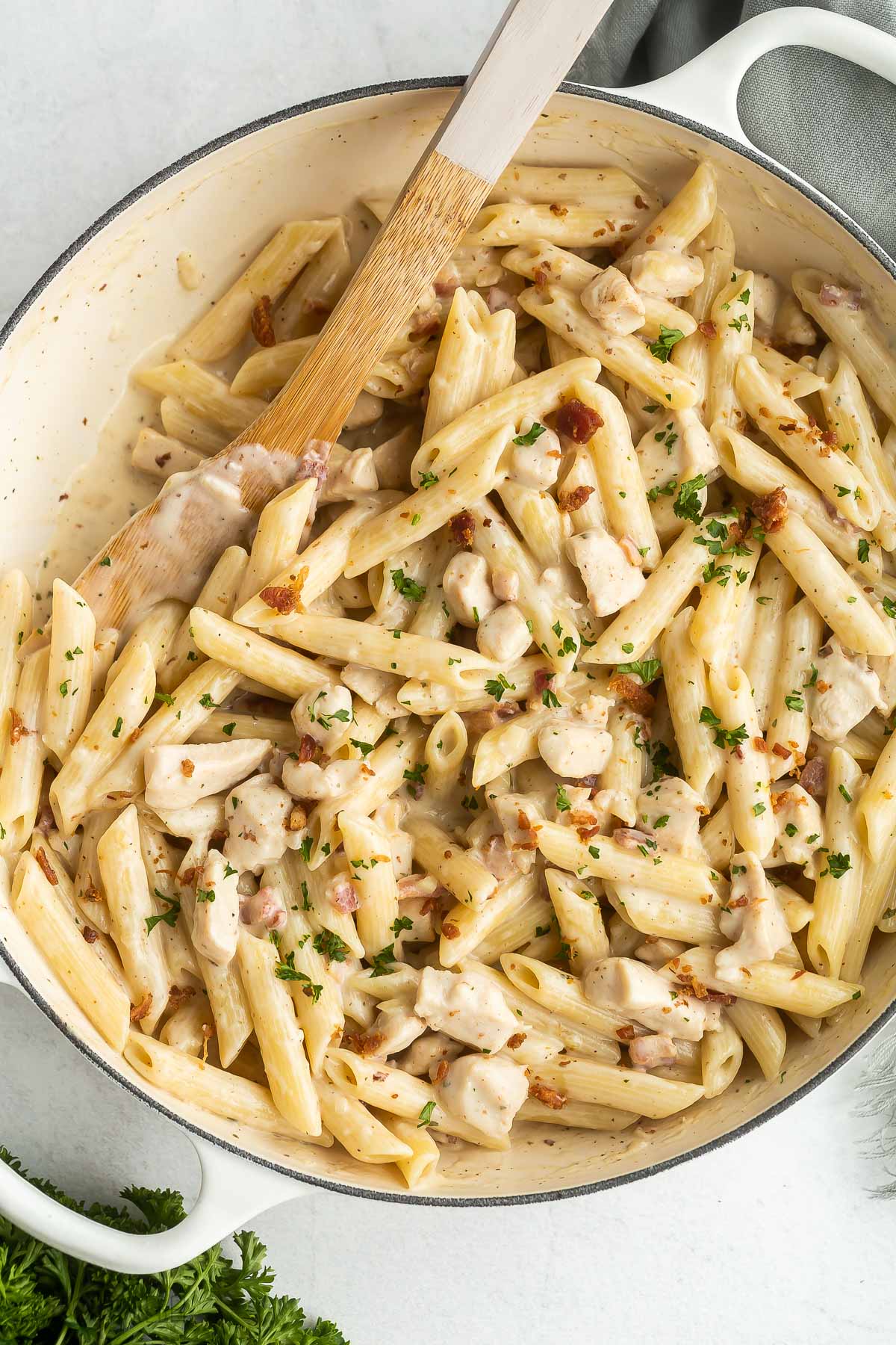 close up image of penne pasta with chicken and bacon in creamy sauce