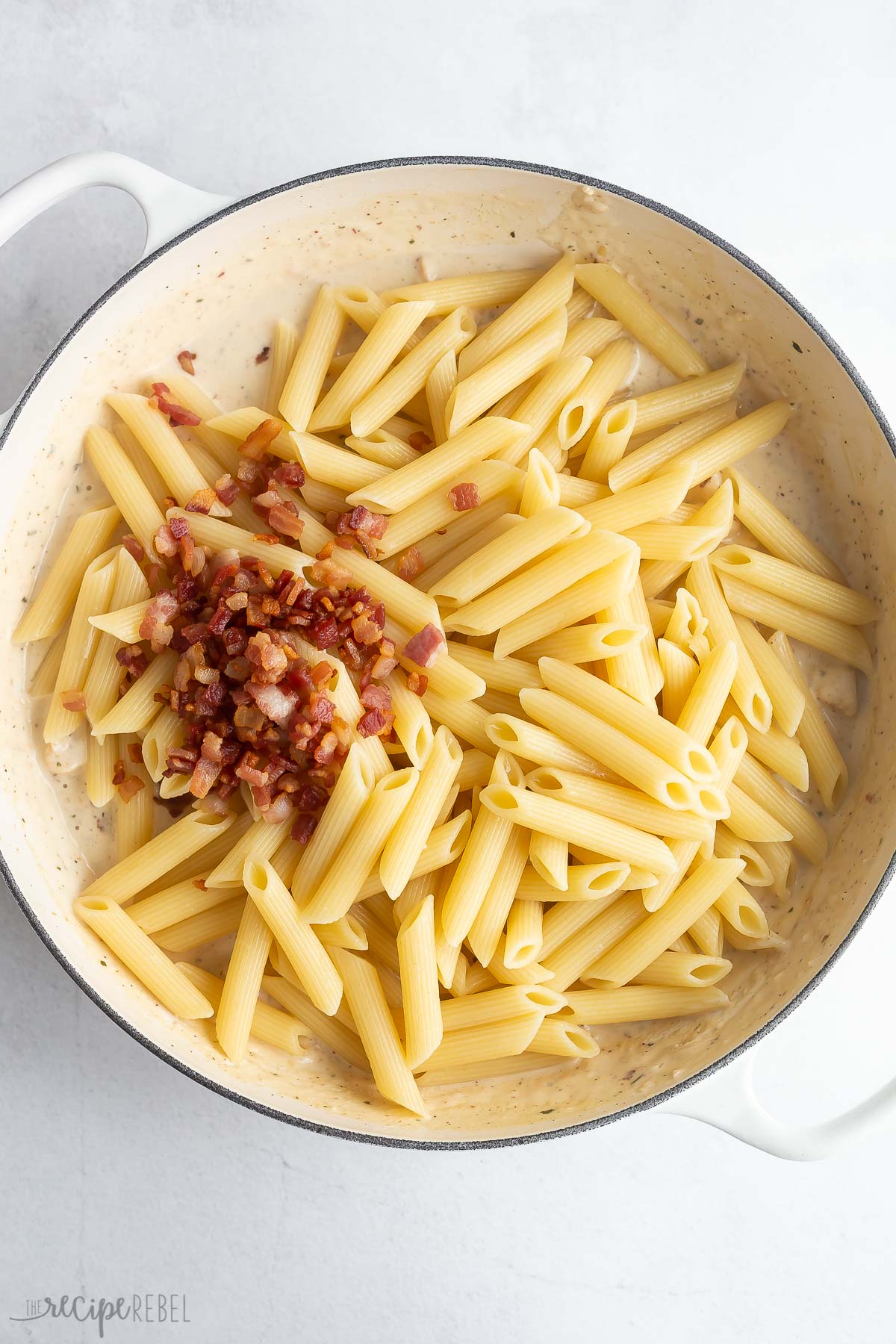 penne pasta added to creamy ranch sauce with bacon