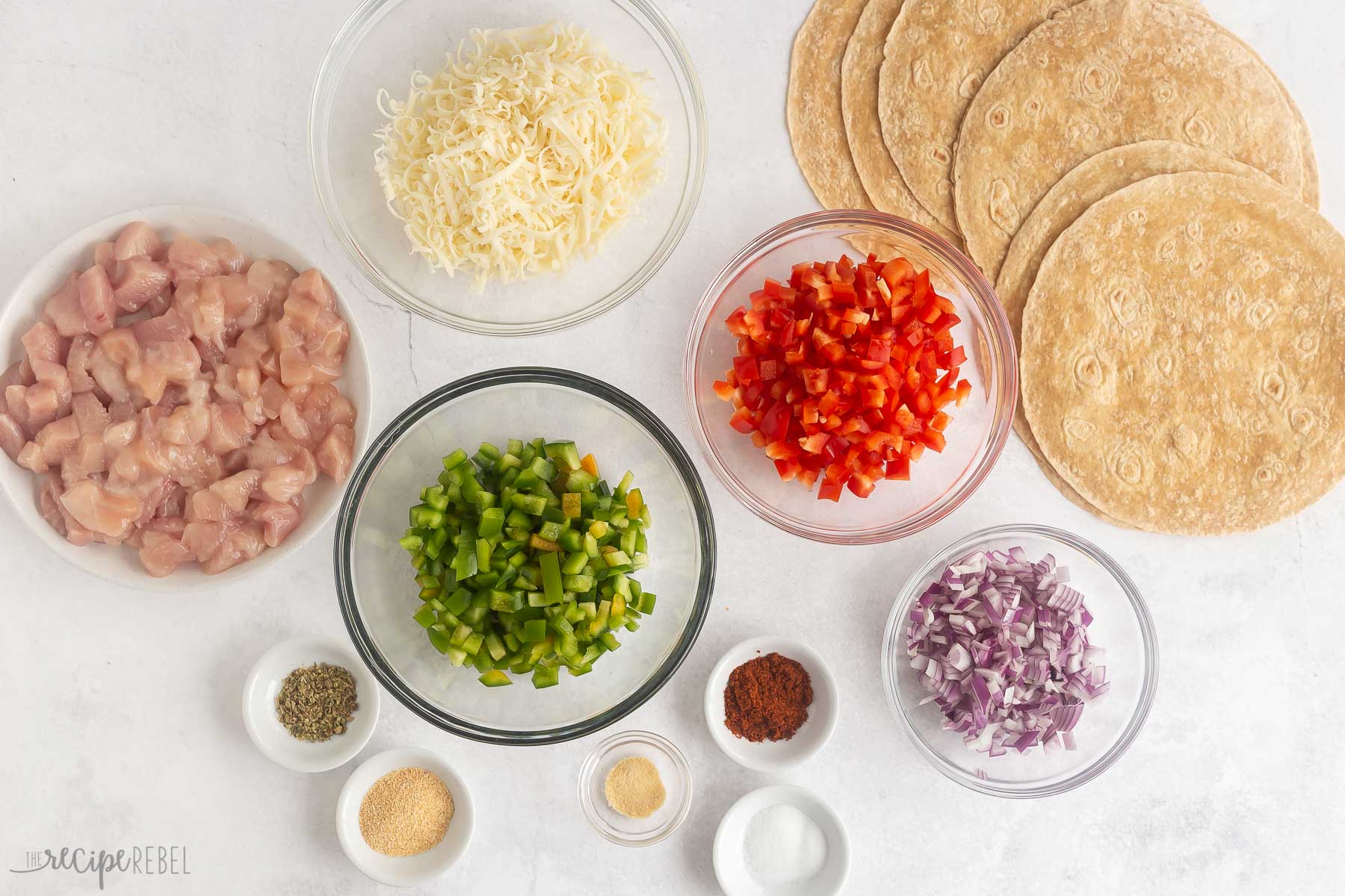 This Chicken Quesadilla is an easy dinner idea! Tortillas layered with juicy bites of chicken, melty cheese, and veggies -- kids and adults love them! #chicken #recipes #dinner | chicken dinner ideas | easy dinner ideas | easy recipes | recipes for kids | chicken breast ingredients needed for chicken quesadillas.