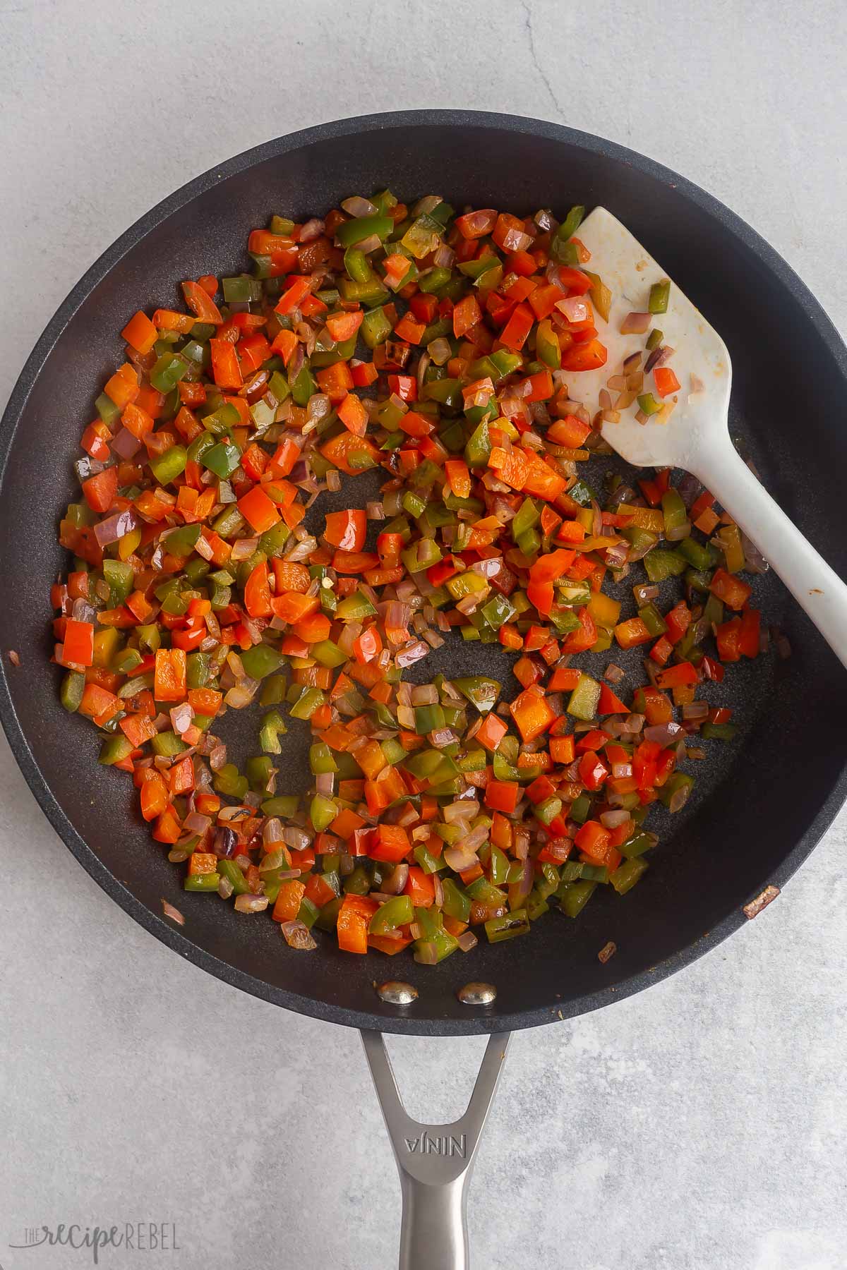 peppers and onions cooked in a skillet.