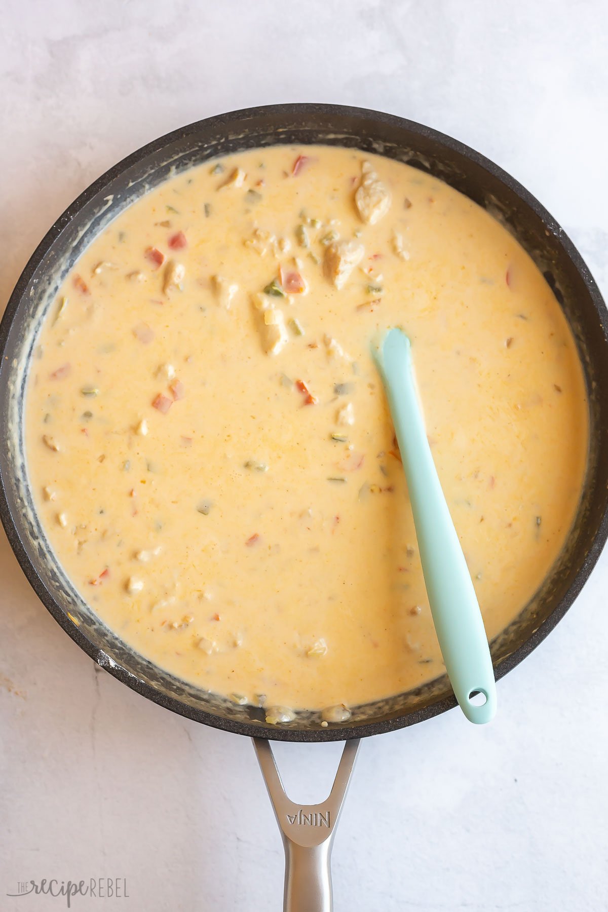 creamy cheesy sauce in skillet for chicken spaghetti.