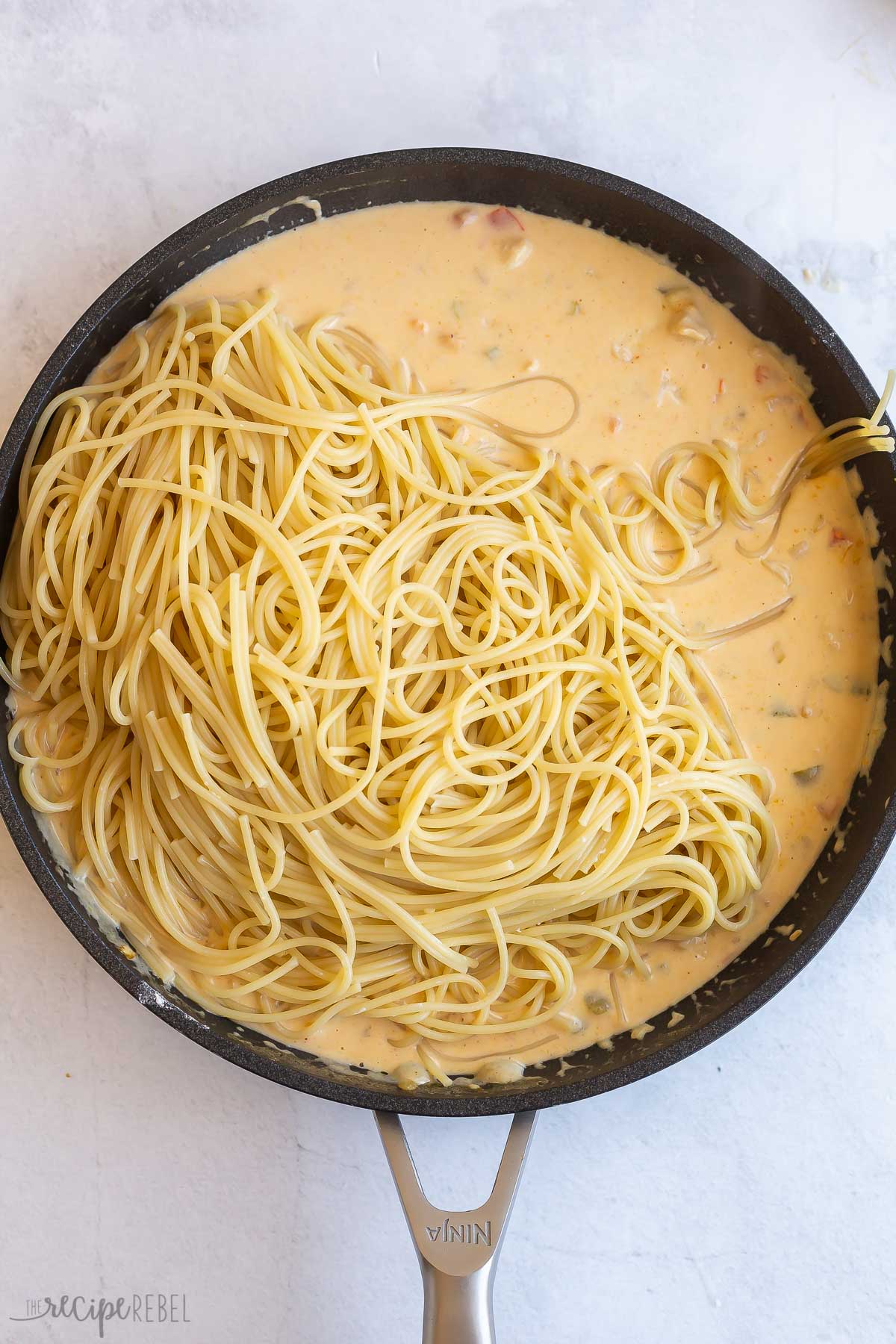 cooked spaghetti noodles added to creamy chicken sauce.