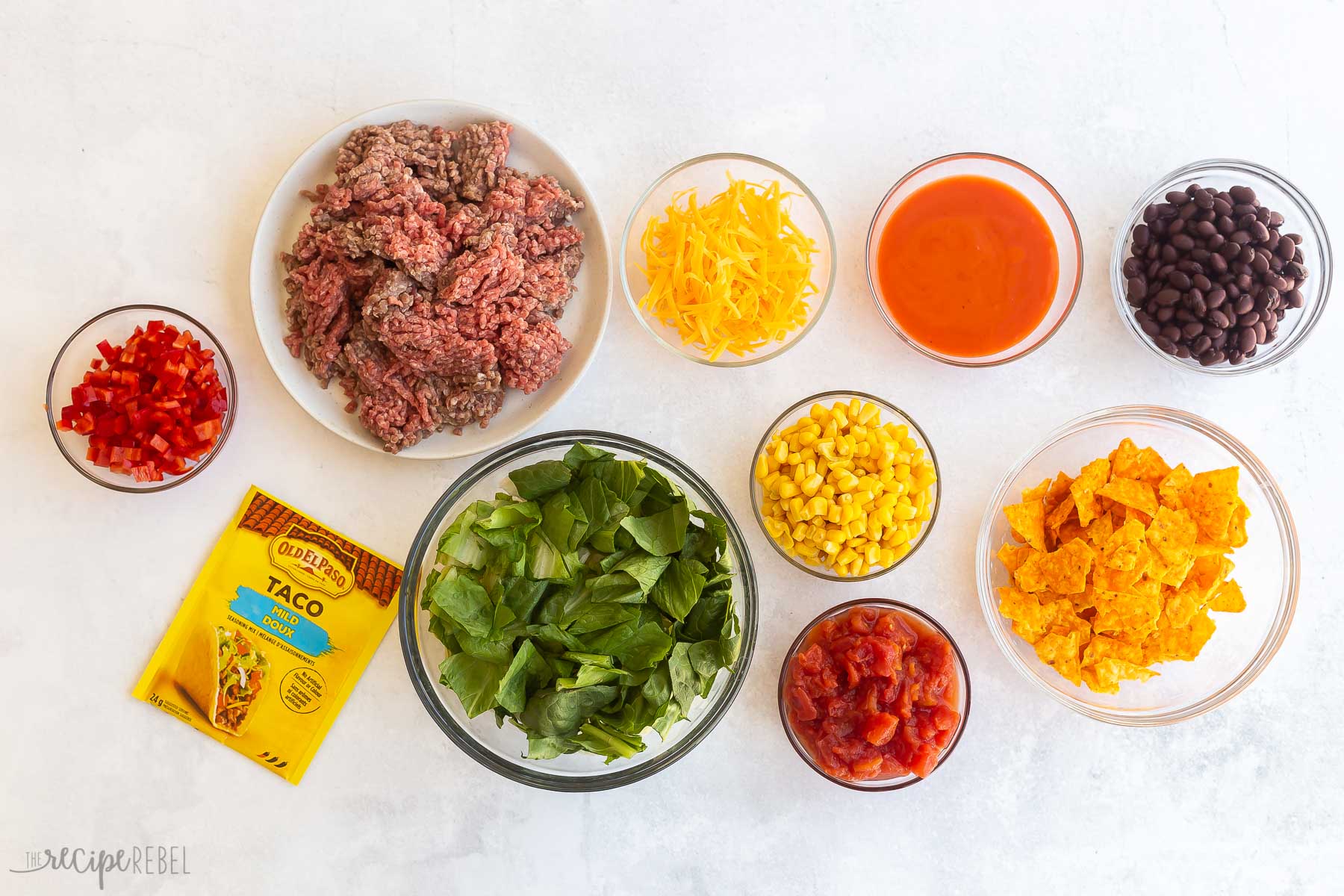 ingredients needed for taco salad on a white background