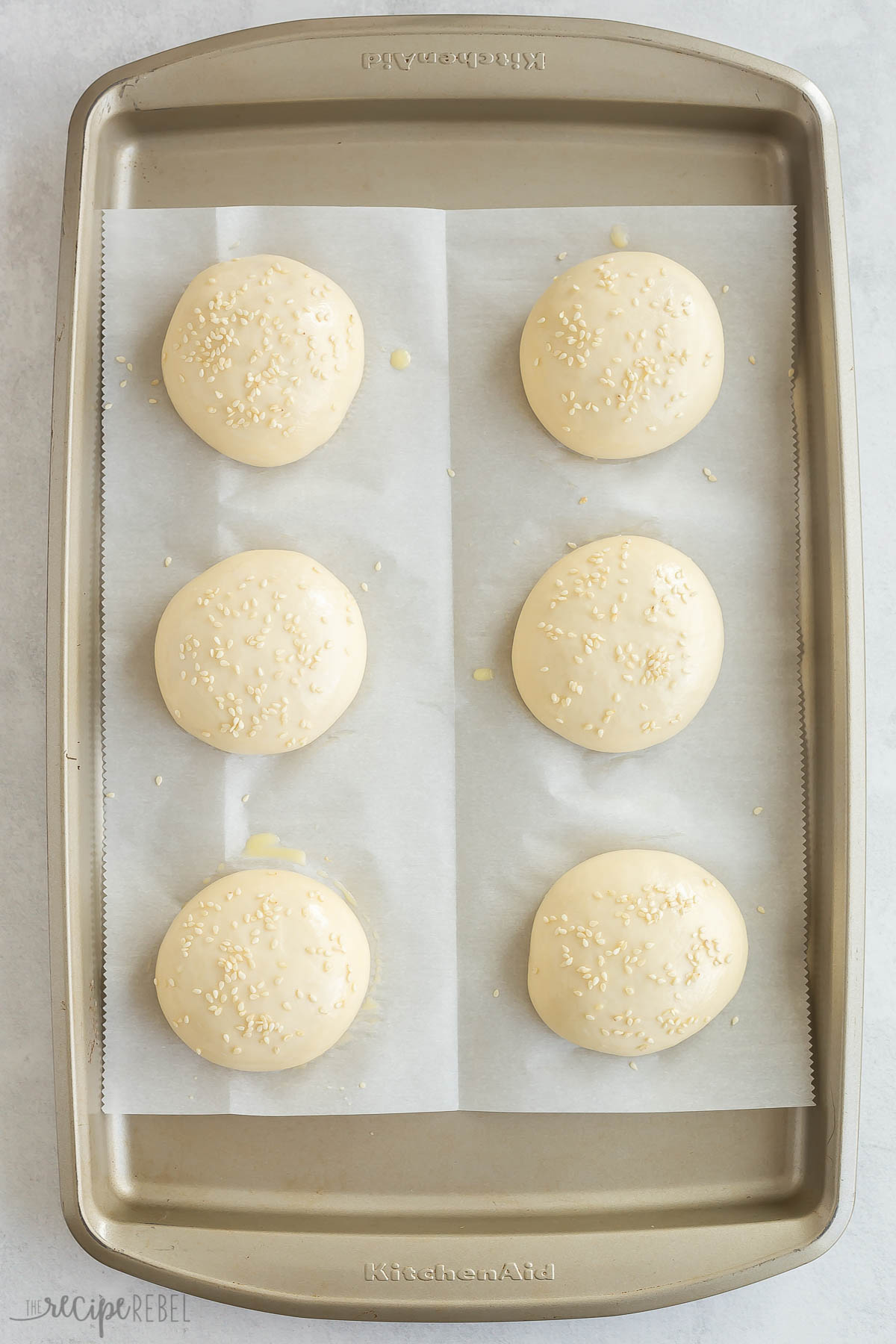 buns on a baking sheet ready to rise