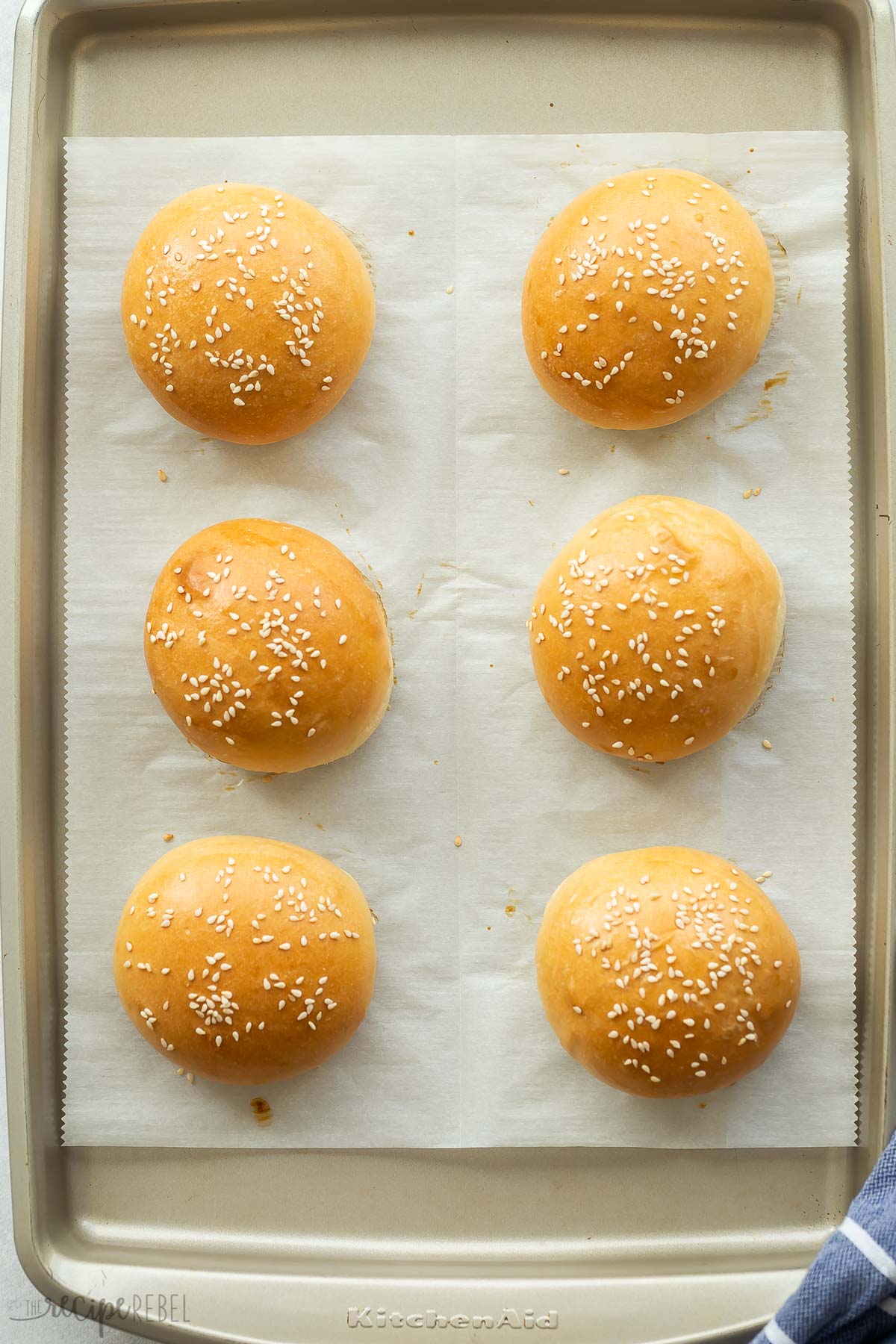 homemade burger buns on baking sheet after baking