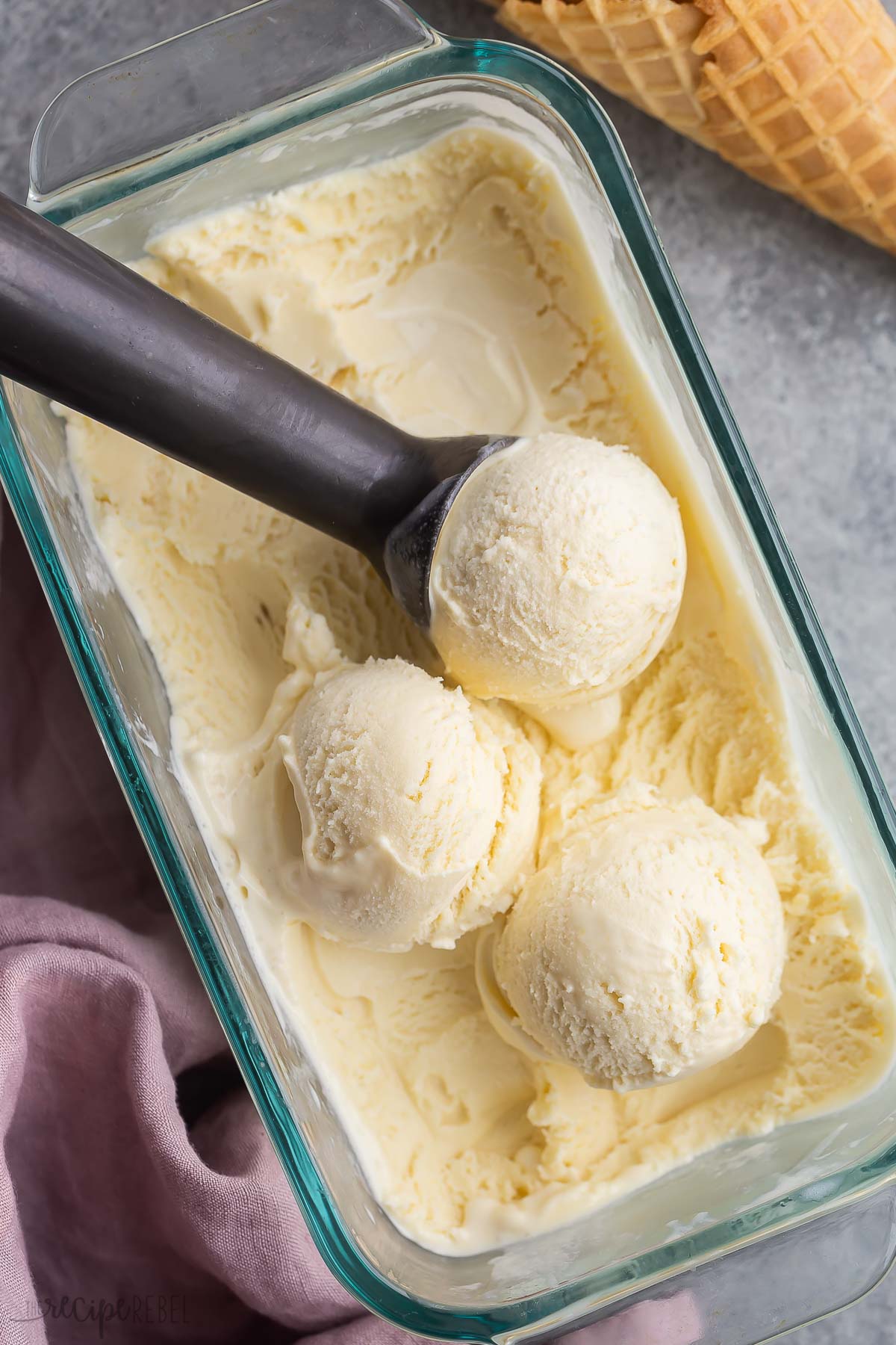 overhead image of pan of ice cream with three scoops sitting on top.