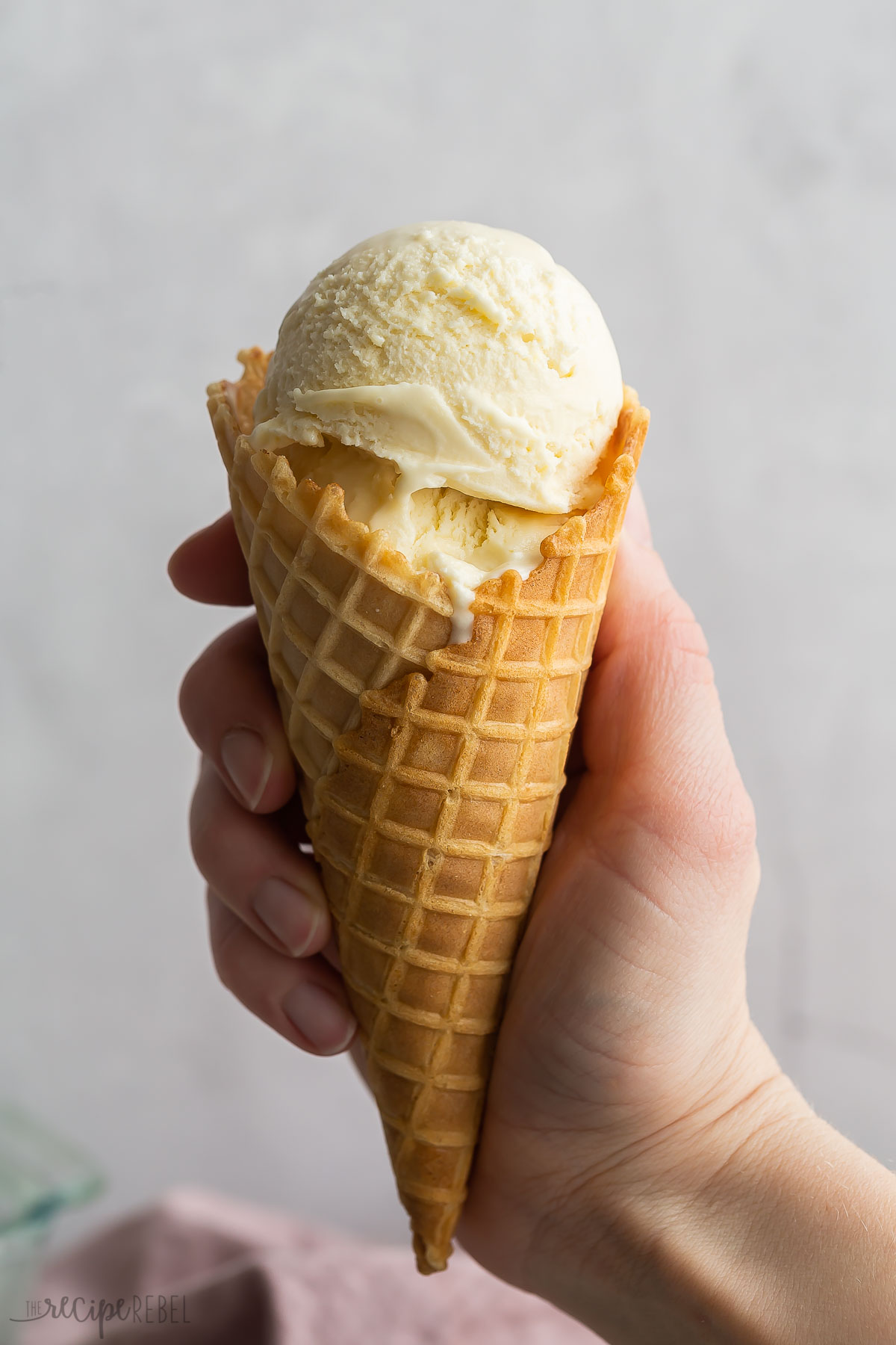 two scoops of frozen custard ice cream in waffle cone.