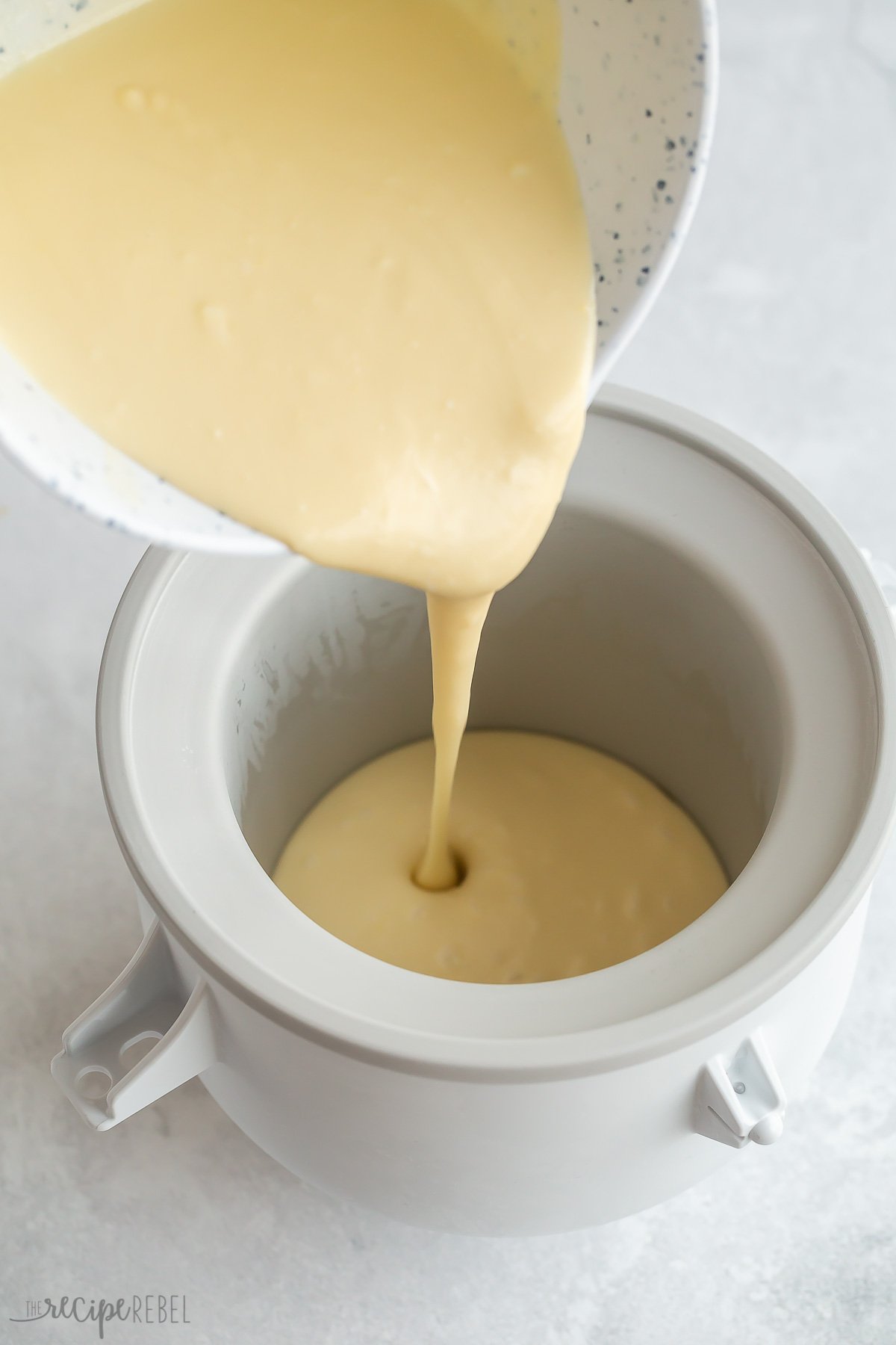 ice cream base being poured into ice cream maker.