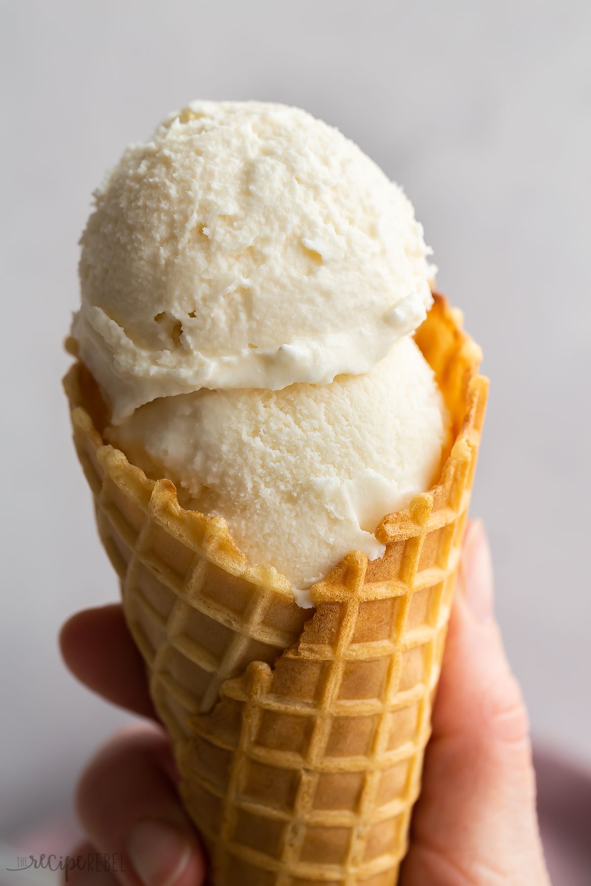 two scoops of homemade ice cream in a cone.