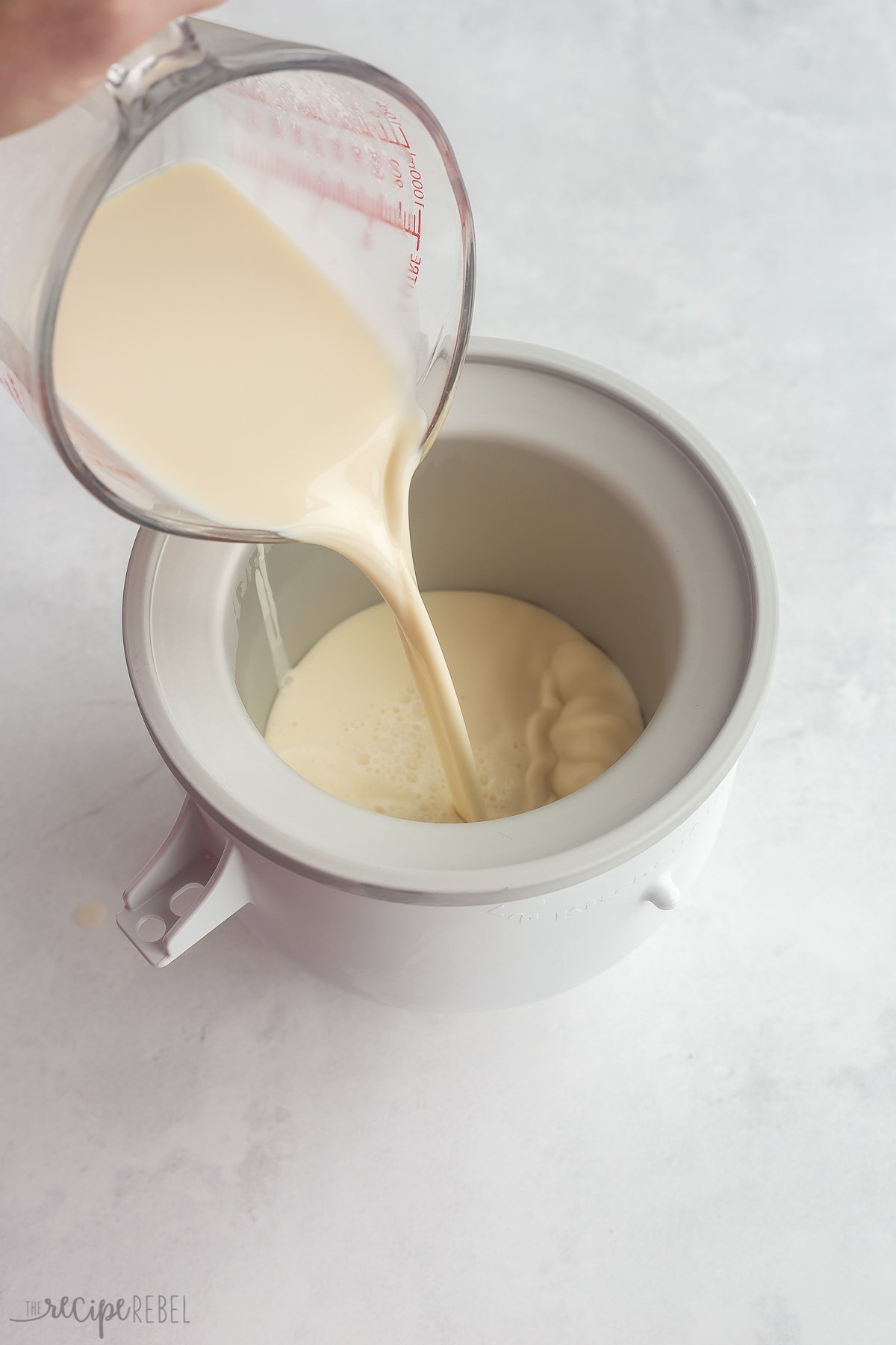 pouring ice cream base into ice cream maker.