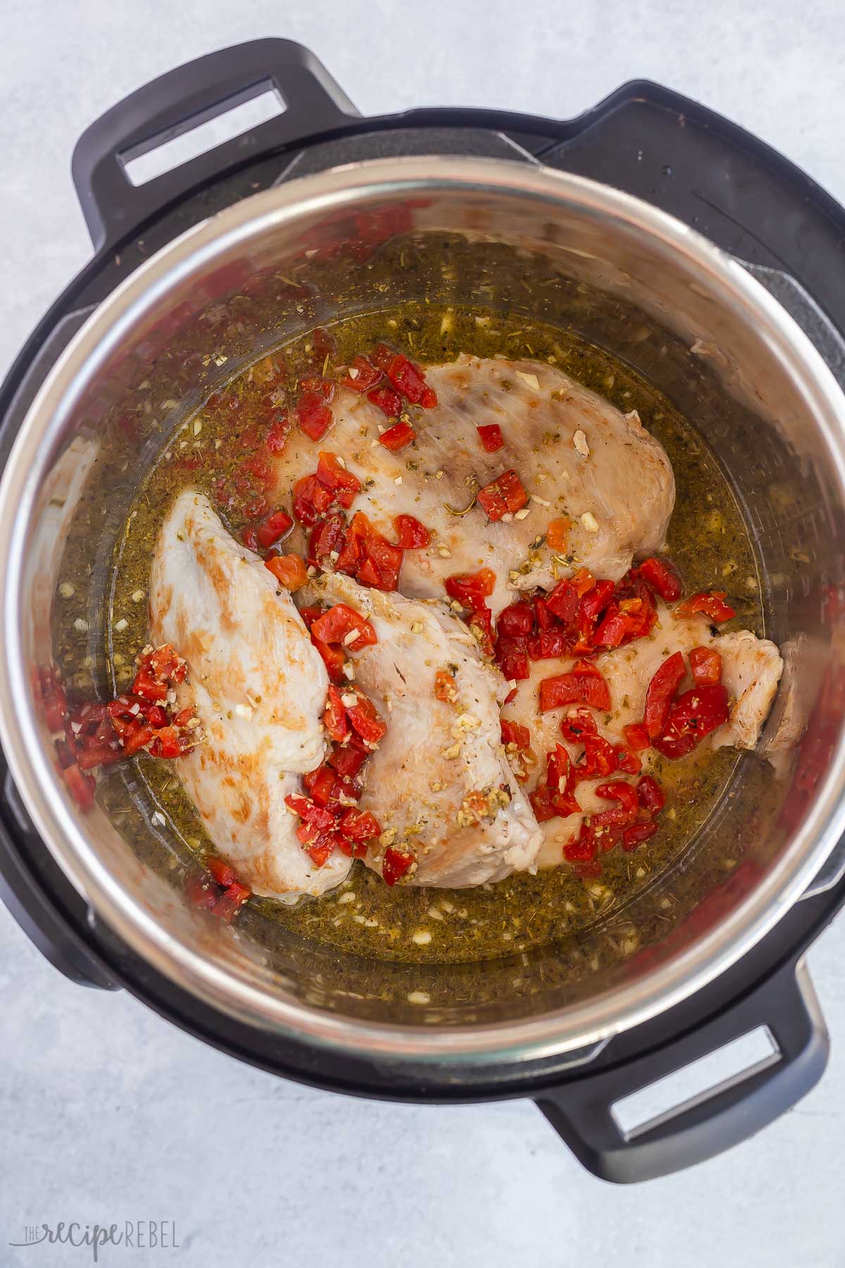 chicken breasts with sauce and roasted red peppers in instant pot