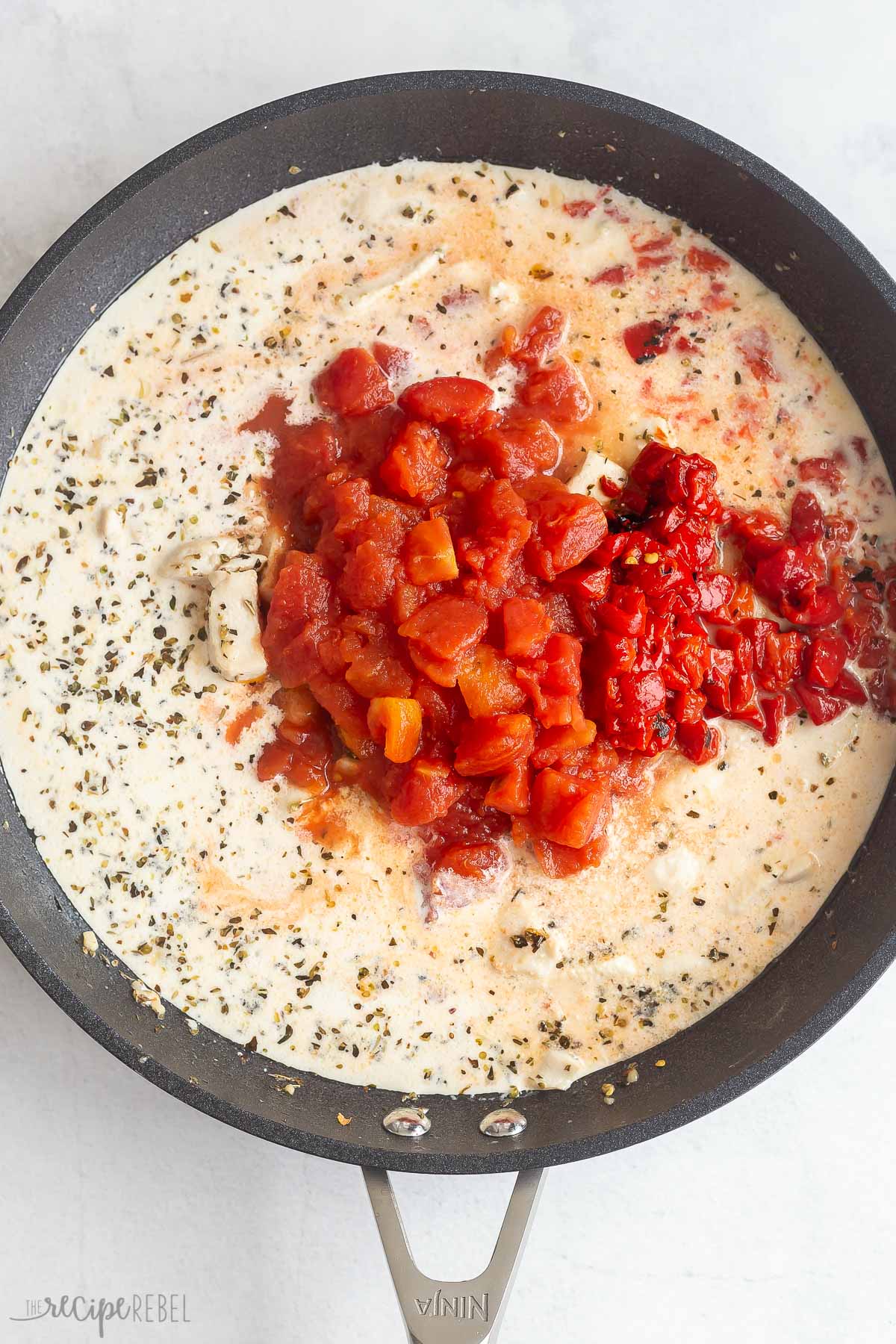 liquids and diced tomatoes added to skillet with chicken.