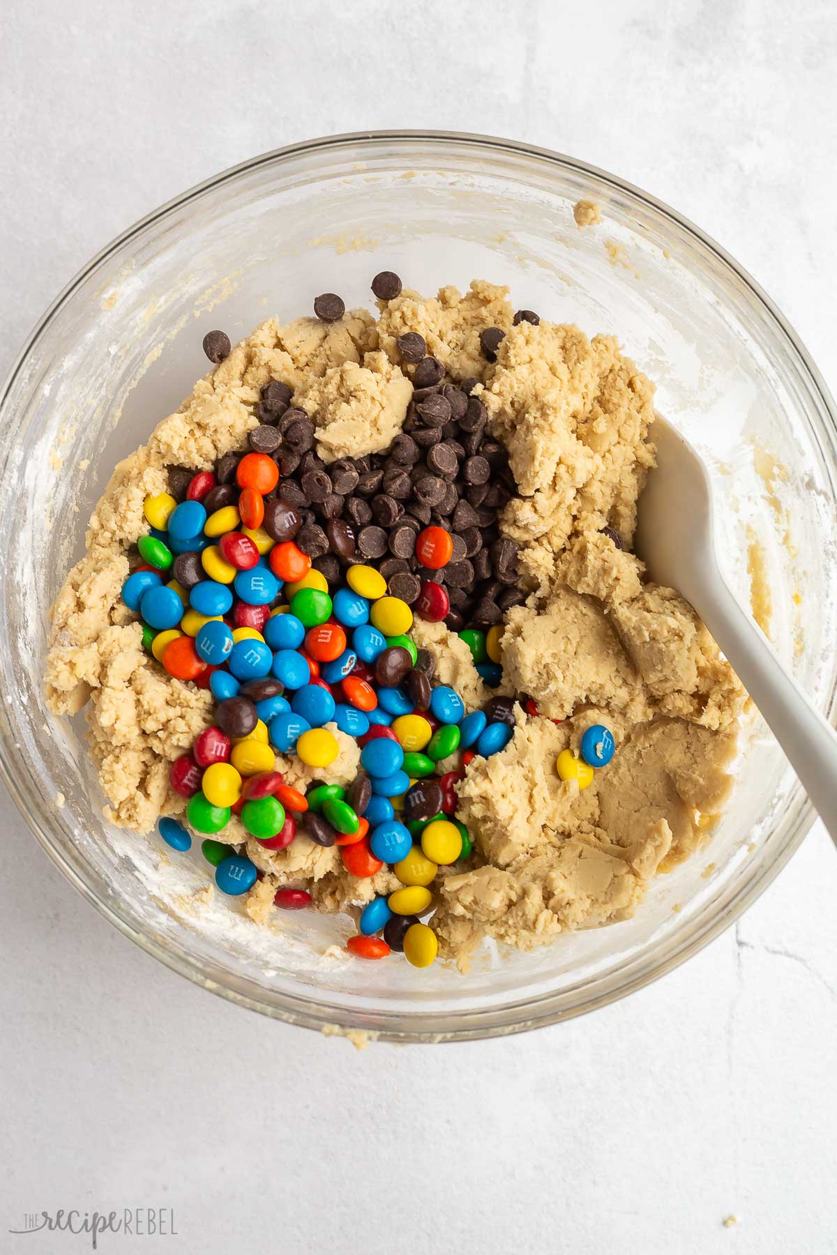chocolate chips and M&Ms added to cookie dough.