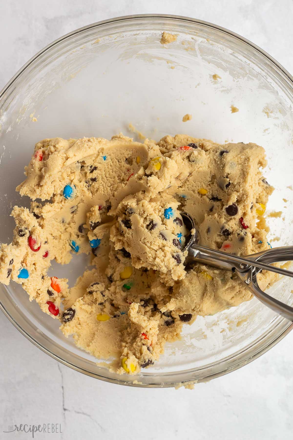 cookie scoop scooping M&M cookie dough.