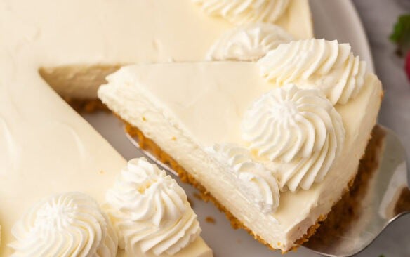 square image of one piece of no bake cheesecake being removed from the whole.