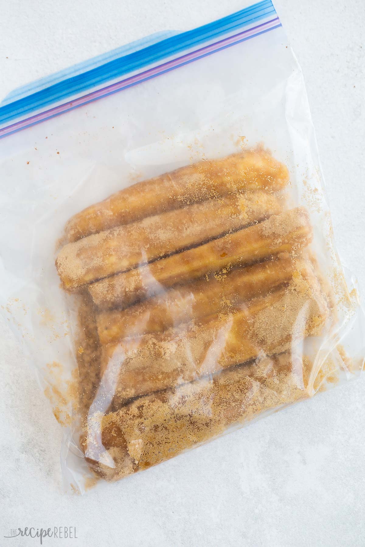 pineapple spears coated in brown sugar in large zip top bag.